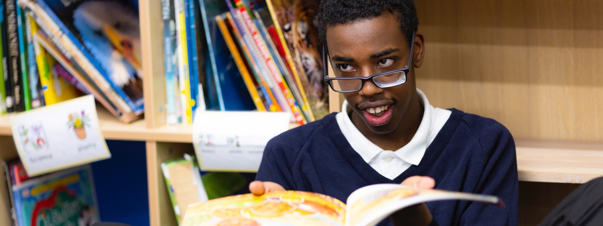 Student in library reading book