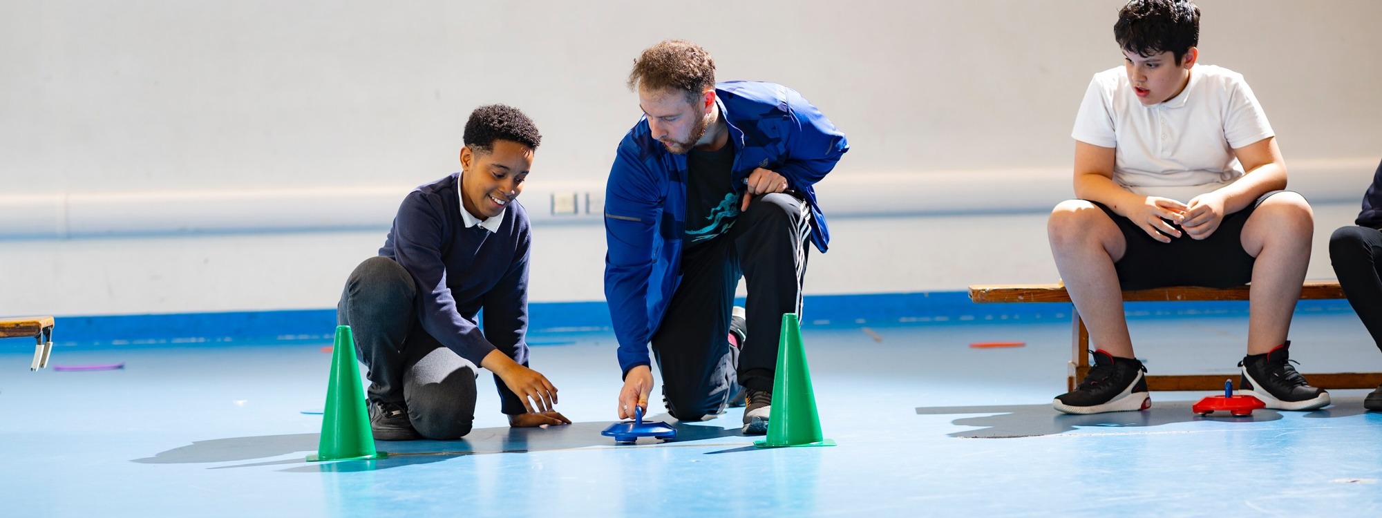 Student with teacher playing with toy cars